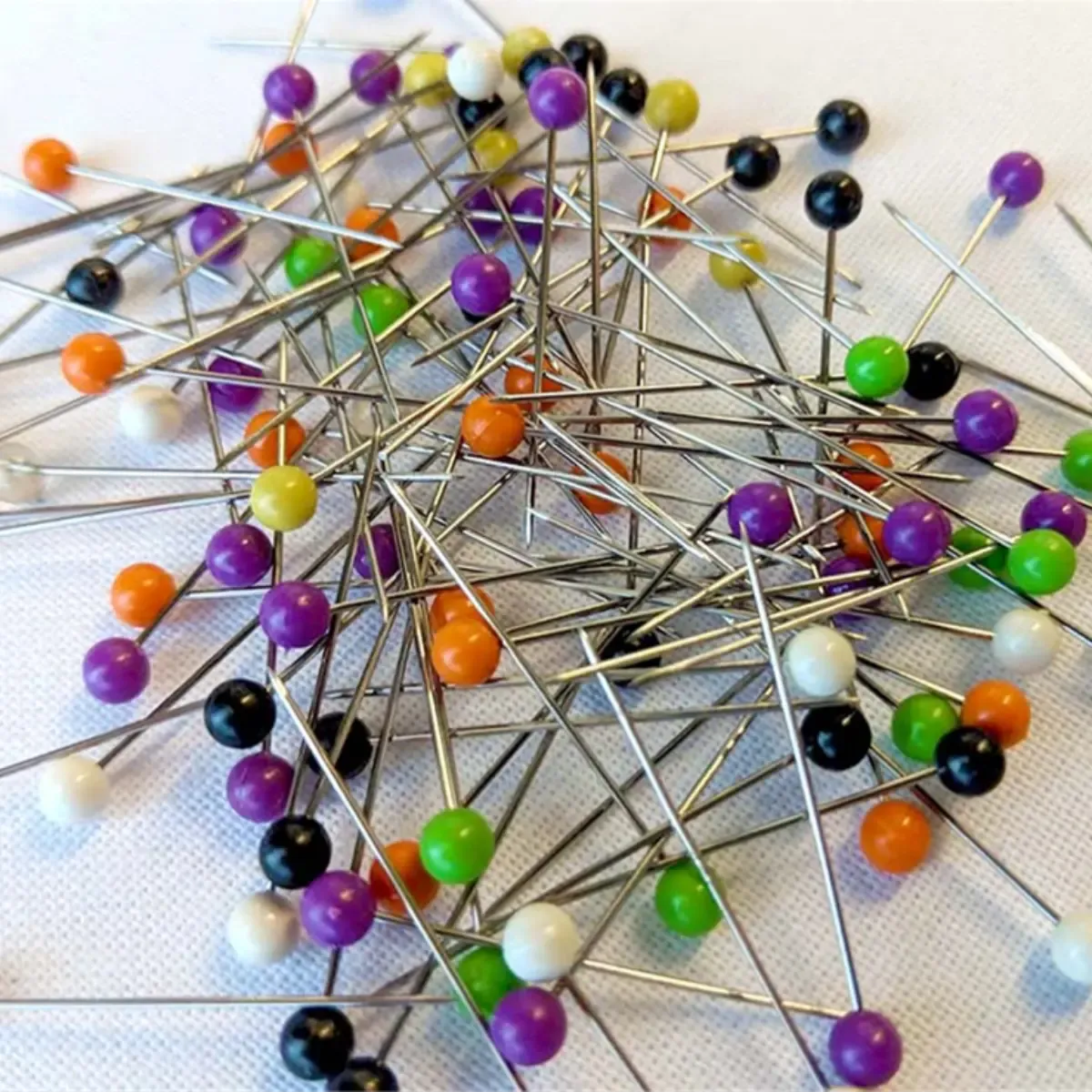 Colour Headed Pins In A Round Tub With A Foam Top Cushion